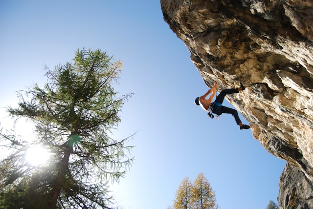 Man climbing on a rock face on a beautiful sunny day