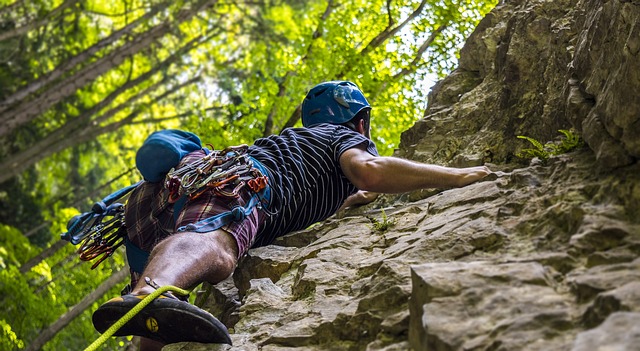 A climber ascending a rock face in a scenic outdoor setting