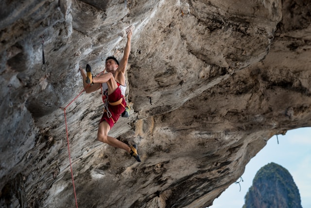 climber lead climbing up a rock face